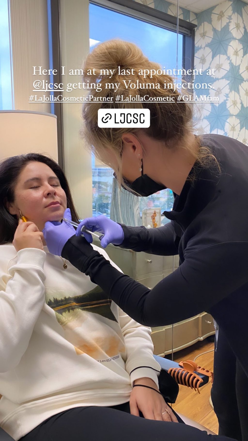 Pamela sitting in a chair at the LJC office as nurse injector Brittany adds her Voluma injections